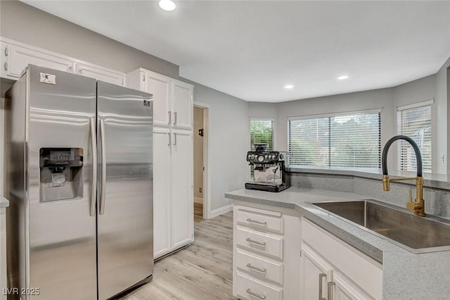2224 Lucerne Ct, Henderson, NV 89014 - kitchen featuring stainless steel refrigerator with ice dispenser, a sink, light wood finished floors, white cabinetry, and recessed lighting