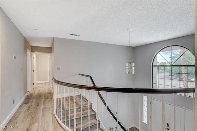 2224 Lucerne Ct, Henderson, NV 89014 - hallway featuring light wood-style floors, a textured ceiling, and baseboards