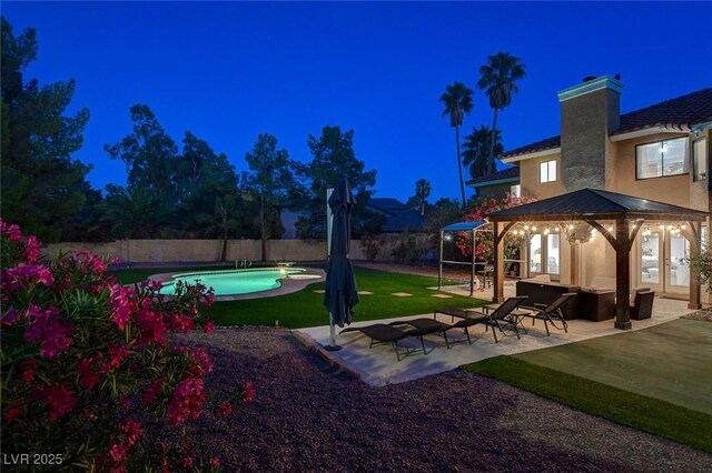 2224 Lucerne Ct, Henderson, NV 89014 - yard at night featuring a gazebo, a fenced backyard, a patio, and french doors