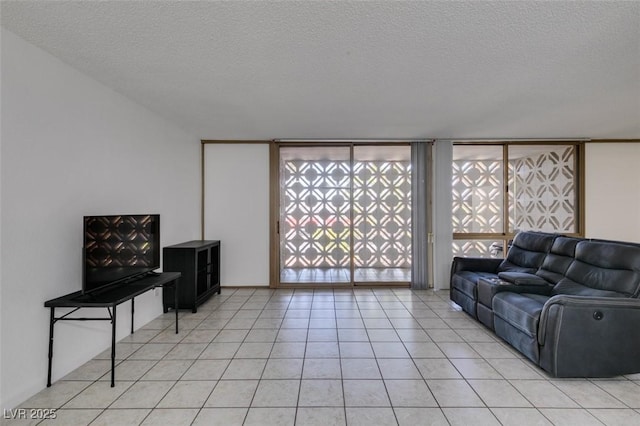living room with a textured ceiling and light tile patterned flooring