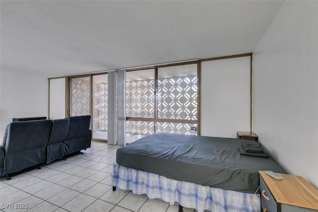bedroom featuring a textured ceiling and light tile patterned floors