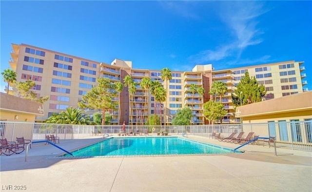 community pool featuring fence and a patio area