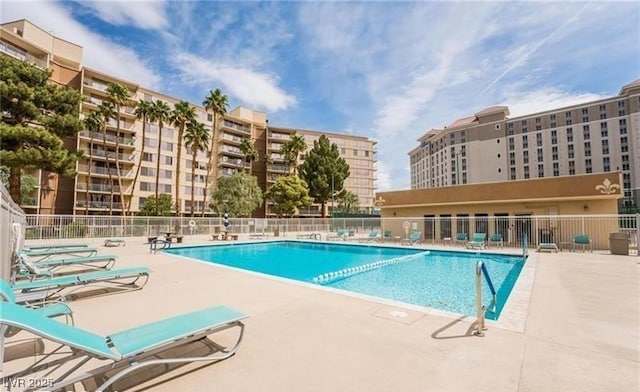 community pool featuring fence and a patio