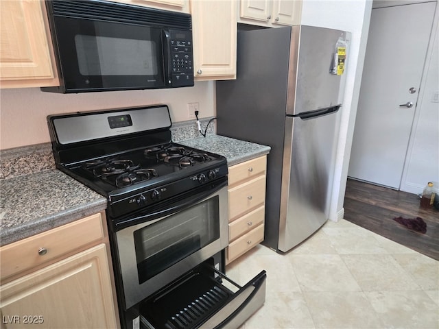 kitchen featuring stainless steel appliances and light brown cabinetry