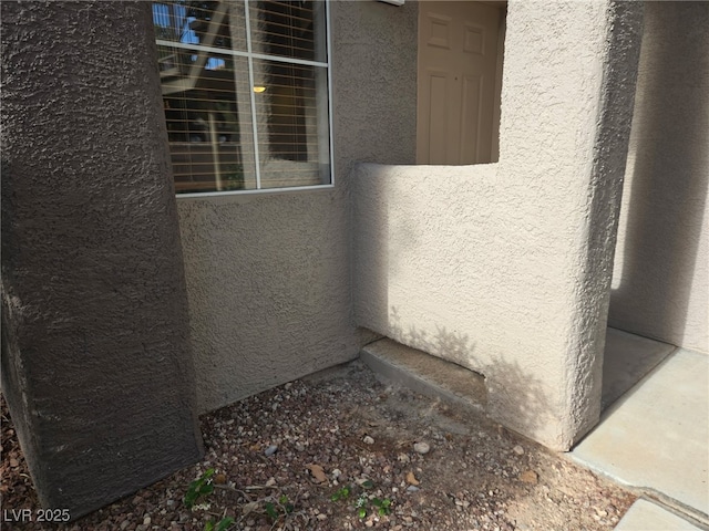 view of side of home with stucco siding
