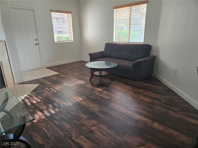 living area with dark wood finished floors and baseboards
