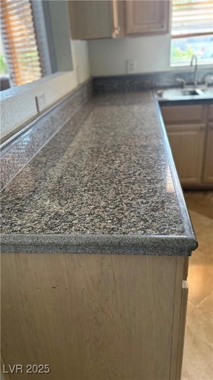 kitchen featuring dark countertops and a sink