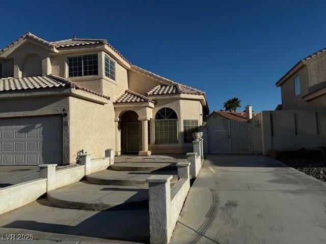 529 Rancho Del Mar Way N, Las Vegas, NV 89031 - mediterranean / spanish house with a gate, stucco siding, a tiled roof, and concrete driveway
