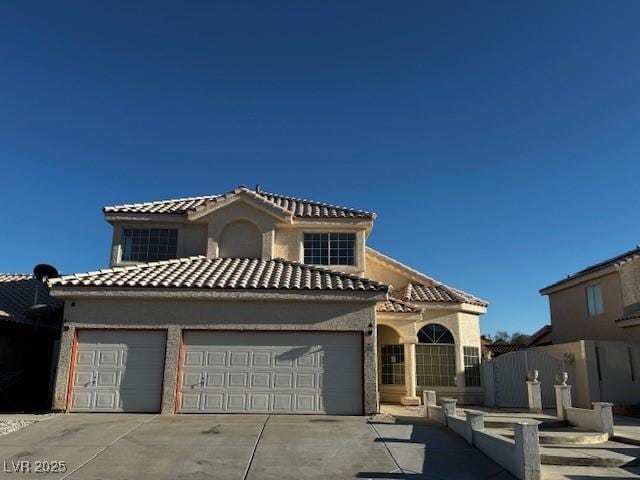 529 Rancho Del Mar Way N, Las Vegas, NV 89031 - mediterranean / spanish house with a garage, concrete driveway, stucco siding, and a tile roof