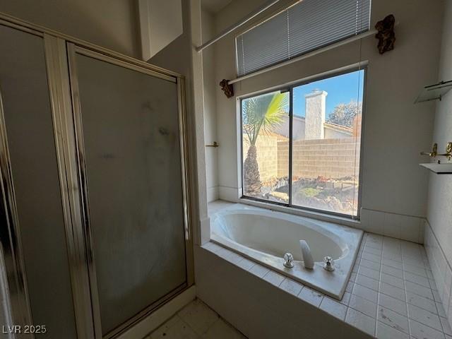 529 Rancho Del Mar Way N, Las Vegas, NV 89031 - bathroom with a stall shower, a garden tub, and tile patterned flooring