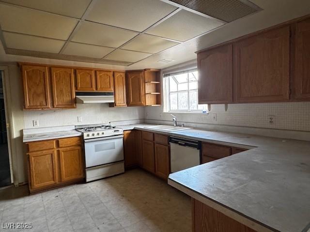 1126 Azul Way, Boulder City, NV 89005 - kitchen featuring white range with gas cooktop, dishwasher, under cabinet range hood, and brown cabinets