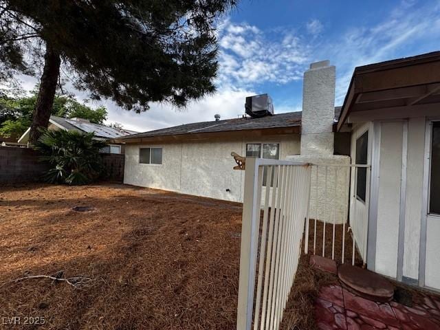 1126 Azul Way, Boulder City, NV 89005 - view of side of property with a chimney and a central AC unit