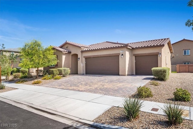 3708 Fuselier Dr, North Las Vegas, NV 89032 - mediterranean / spanish-style home featuring stucco siding, a tiled roof, and a garage