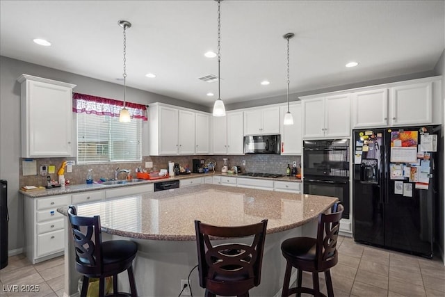 3708 Fuselier Dr, North Las Vegas, NV 89032 - kitchen with black appliances, a sink, light tile patterned floors, a kitchen breakfast bar, and white cabinets