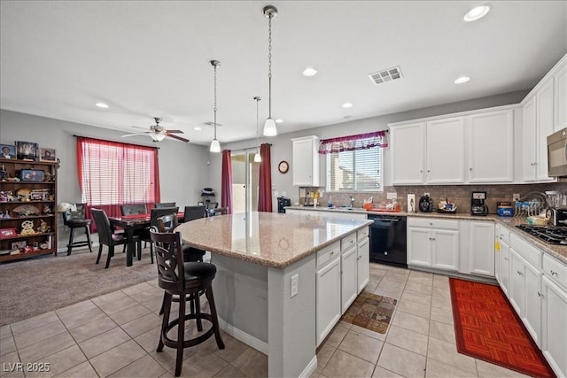 3708 Fuselier Dr, North Las Vegas, NV 89032 - kitchen with black appliances, a kitchen island, light tile patterned floors, ceiling fan, and recessed lighting