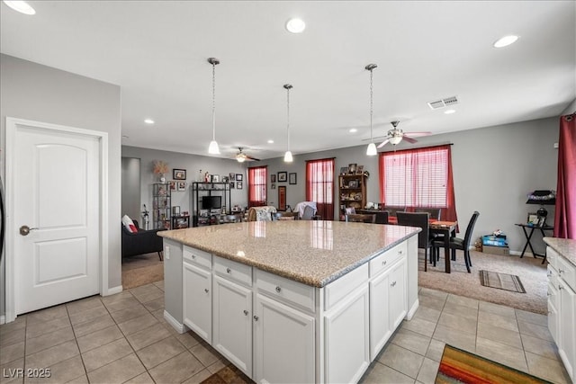 3708 Fuselier Dr, North Las Vegas, NV 89032 - kitchen featuring a ceiling fan, open floor plan, light tile patterned floors, a center island, and recessed lighting