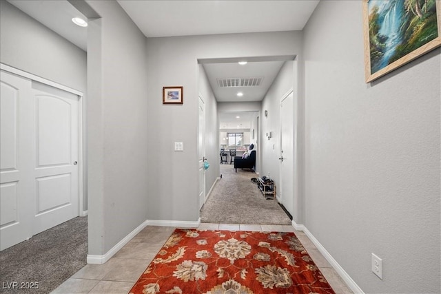 3708 Fuselier Dr, North Las Vegas, NV 89032 - hallway with light tile patterned floors, light carpet, recessed lighting, and baseboards