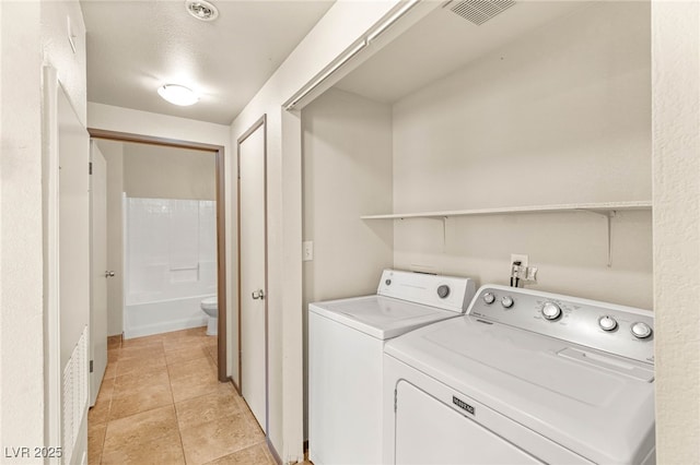 4830 Grey Wolf Ln Unit 104, Las Vegas, NV 89149 - clothes washing area with independent washer and dryer and light tile patterned floors