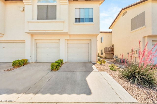 4830 Grey Wolf Ln Unit 104, Las Vegas, NV 89149 - view of front facade with stucco siding, driveway, and a garage