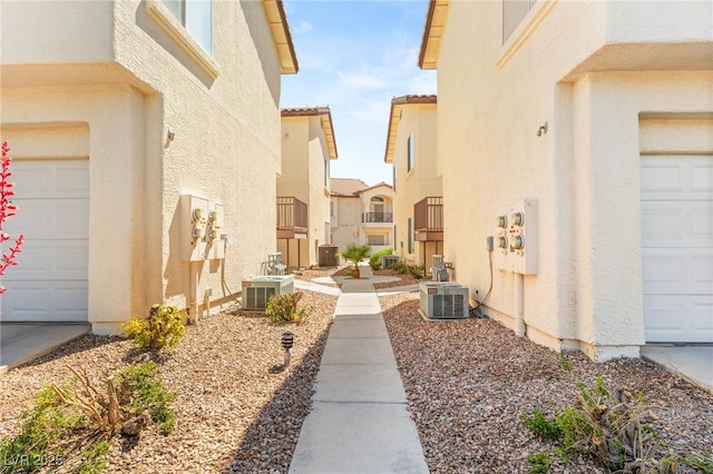 4830 Grey Wolf Ln Unit 104, Las Vegas, NV 89149 - view of property exterior featuring central AC unit, stucco siding, and a garage