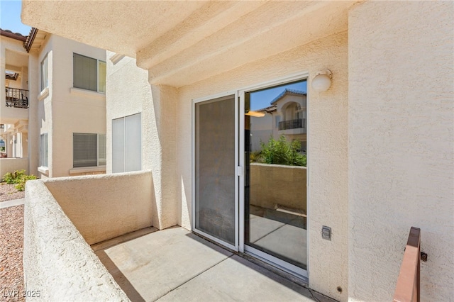 4830 Grey Wolf Ln Unit 104, Las Vegas, NV 89149 - view of exterior entry featuring stucco siding and a balcony