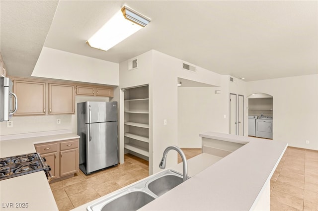 4830 Grey Wolf Ln Unit 104, Las Vegas, NV 89149 - kitchen with freestanding refrigerator, washing machine and dryer, light tile patterned flooring, a sink, and light countertops