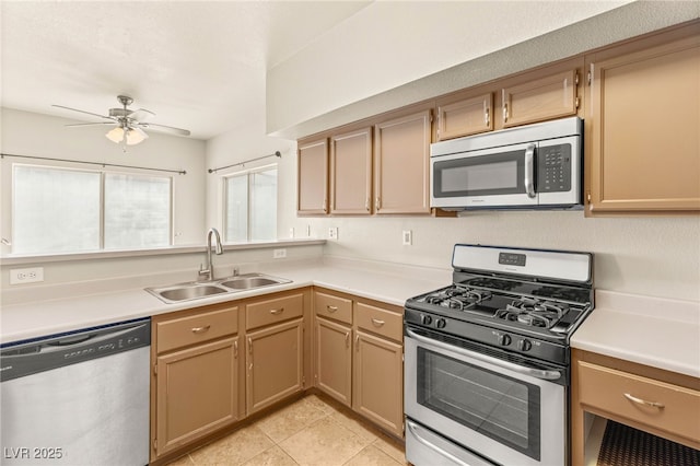 4830 Grey Wolf Ln Unit 104, Las Vegas, NV 89149 - kitchen featuring stainless steel appliances, a sink, a ceiling fan, light countertops, and light tile patterned floors