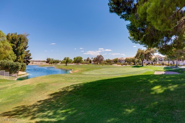 4830 Grey Wolf Ln Unit 104, Las Vegas, NV 89149 - view of property's community featuring a water view, a lawn, and view of golf course