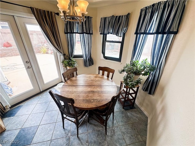 dining space featuring a chandelier and baseboards