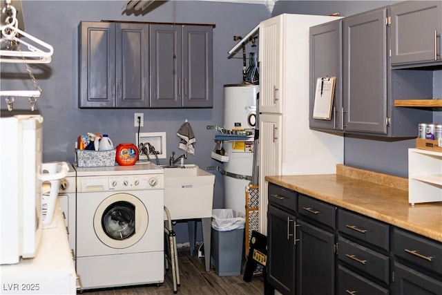 clothes washing area with washing machine and dryer, cabinet space, and dark wood-style flooring