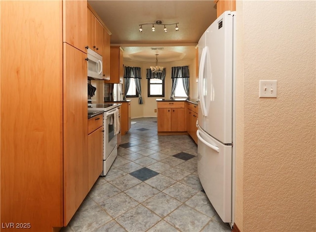2822 La Palma Dr, Laughlin, NV 89029 - kitchen with white appliances, a textured wall, dark countertops, a chandelier, and pendant lighting