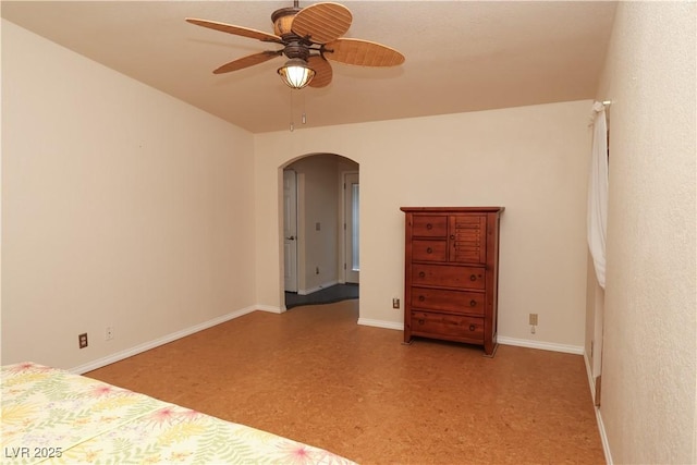 2822 La Palma Dr, Laughlin, NV 89029 - unfurnished bedroom with arched walkways, baseboards, and ceiling fan