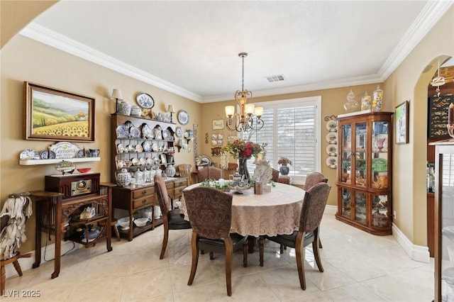 7301 Heggie Ave, Las Vegas, NV 89131 - dining space featuring ornamental molding, a chandelier, arched walkways, light tile patterned floors, and baseboards