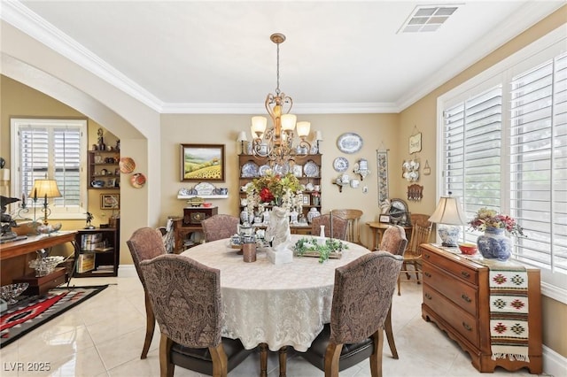 7301 Heggie Ave, Las Vegas, NV 89131 - dining room featuring a chandelier, light tile patterned flooring, and crown molding