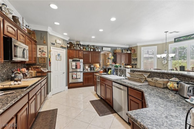 7301 Heggie Ave, Las Vegas, NV 89131 - kitchen featuring stainless steel appliances, a sink, ornamental molding, tasteful backsplash, and a chandelier