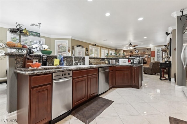 7301 Heggie Ave, Las Vegas, NV 89131 - kitchen with stainless steel dishwasher, crown molding, recessed lighting, light tile patterned floors, and open floor plan