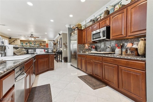 7301 Heggie Ave, Las Vegas, NV 89131 - kitchen with appliances with stainless steel finishes, decorative backsplash, crown molding, recessed lighting, and ceiling fan