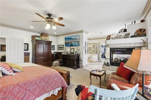 7301 Heggie Ave, Las Vegas, NV 89131 - carpeted bedroom featuring crown molding, a tiled fireplace, recessed lighting, ceiling fan, and connected bathroom