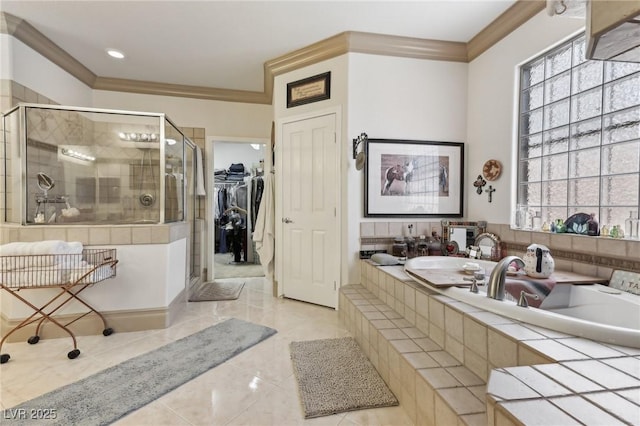 7301 Heggie Ave, Las Vegas, NV 89131 - bathroom with crown molding, a shower stall, a garden tub, a spacious closet, and tile patterned floors