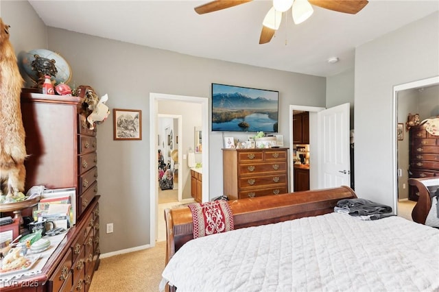 7301 Heggie Ave, Las Vegas, NV 89131 - bedroom with light colored carpet, ensuite bathroom, a ceiling fan, and baseboards