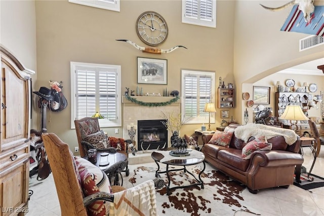 7301 Heggie Ave, Las Vegas, NV 89131 - living room featuring tile patterned flooring, a towering ceiling, and a high end fireplace