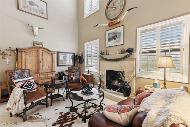 7301 Heggie Ave, Las Vegas, NV 89131 - tiled living area featuring healthy amount of natural light, a premium fireplace, and a high ceiling
