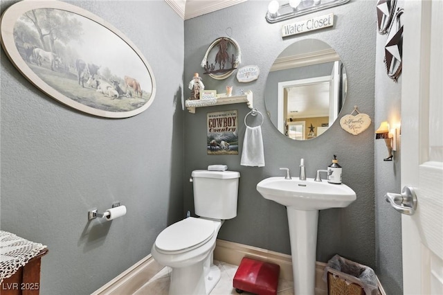 7301 Heggie Ave, Las Vegas, NV 89131 - bathroom featuring toilet, crown molding, baseboards, and a sink