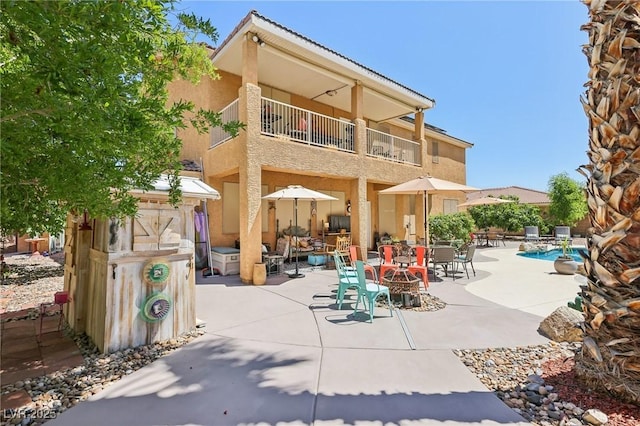 7301 Heggie Ave, Las Vegas, NV 89131 - back of property with a balcony, a patio, and stucco siding