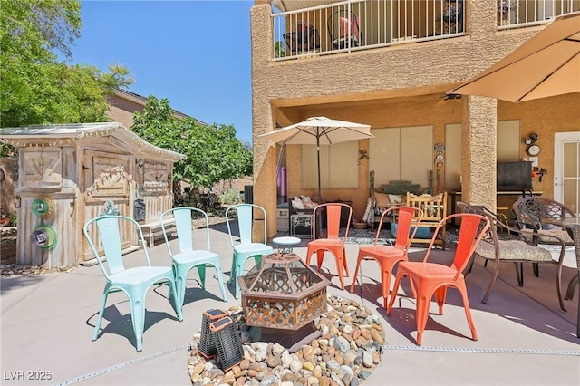 7301 Heggie Ave, Las Vegas, NV 89131 - view of patio / terrace with an outdoor fire pit, a balcony, and outdoor dining area