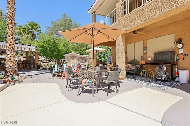 7301 Heggie Ave, Las Vegas, NV 89131 - view of patio / terrace with a balcony, outdoor dining space, and ceiling fan