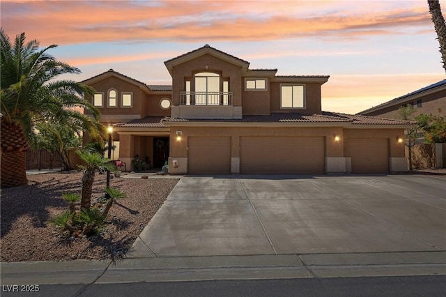 7301 Heggie Ave, Las Vegas, NV 89131 - mediterranean / spanish house featuring stucco siding, driveway, a balcony, a tile roof, and an attached garage
