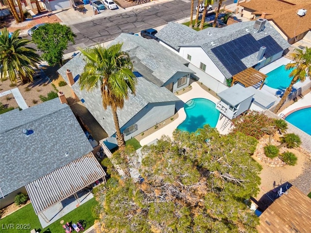 aerial view of property and surrounding area with a pool