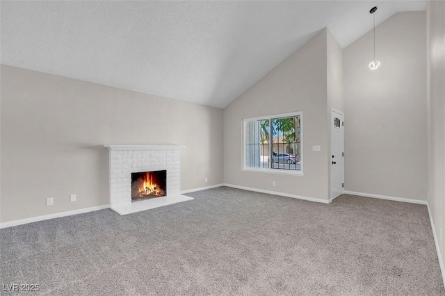 unfurnished living room with carpet floors, high vaulted ceiling, a fireplace, and baseboards