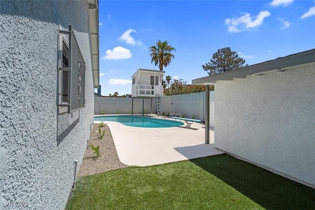 view of pool with a fenced backyard, a diving board, and a patio area